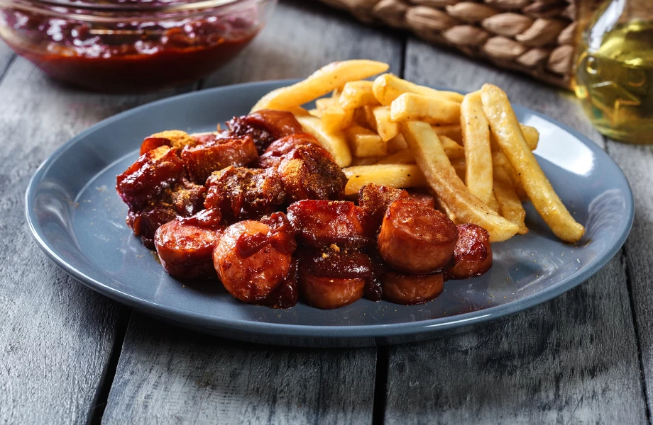 Homemade currywurst with fries on a plate