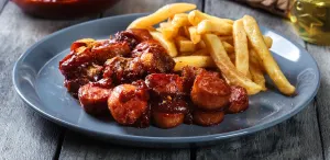 Homemade currywurst with fries on a plate